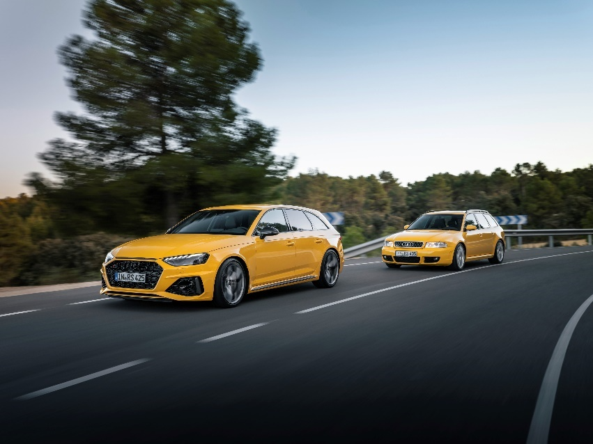 Two yellow cars on a road
Description automatically generated
